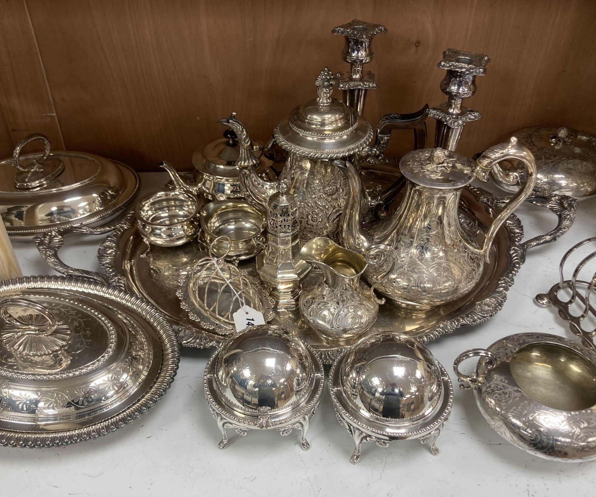 A silver plated tray, pair of candlesticks, teapots, coffee jug, etc.